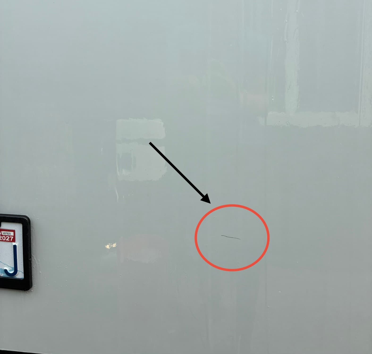 Travel trailer side panel with water spots and scratch before mobile wash and wax in Snohomish, WA