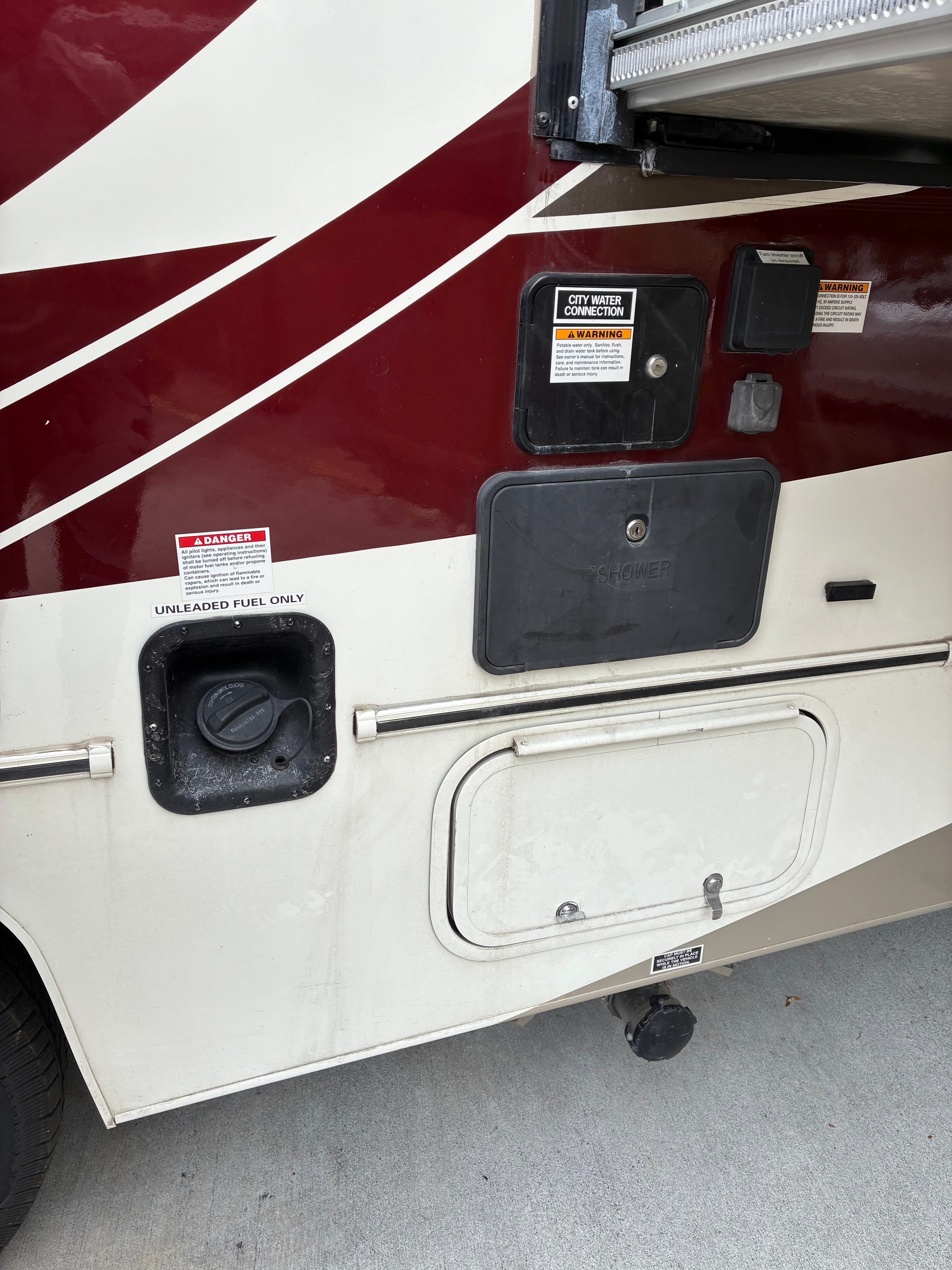 Class A motorhome utility compartment panels with grime and oxidation before mobile wash and wax in Edmonds, WA
