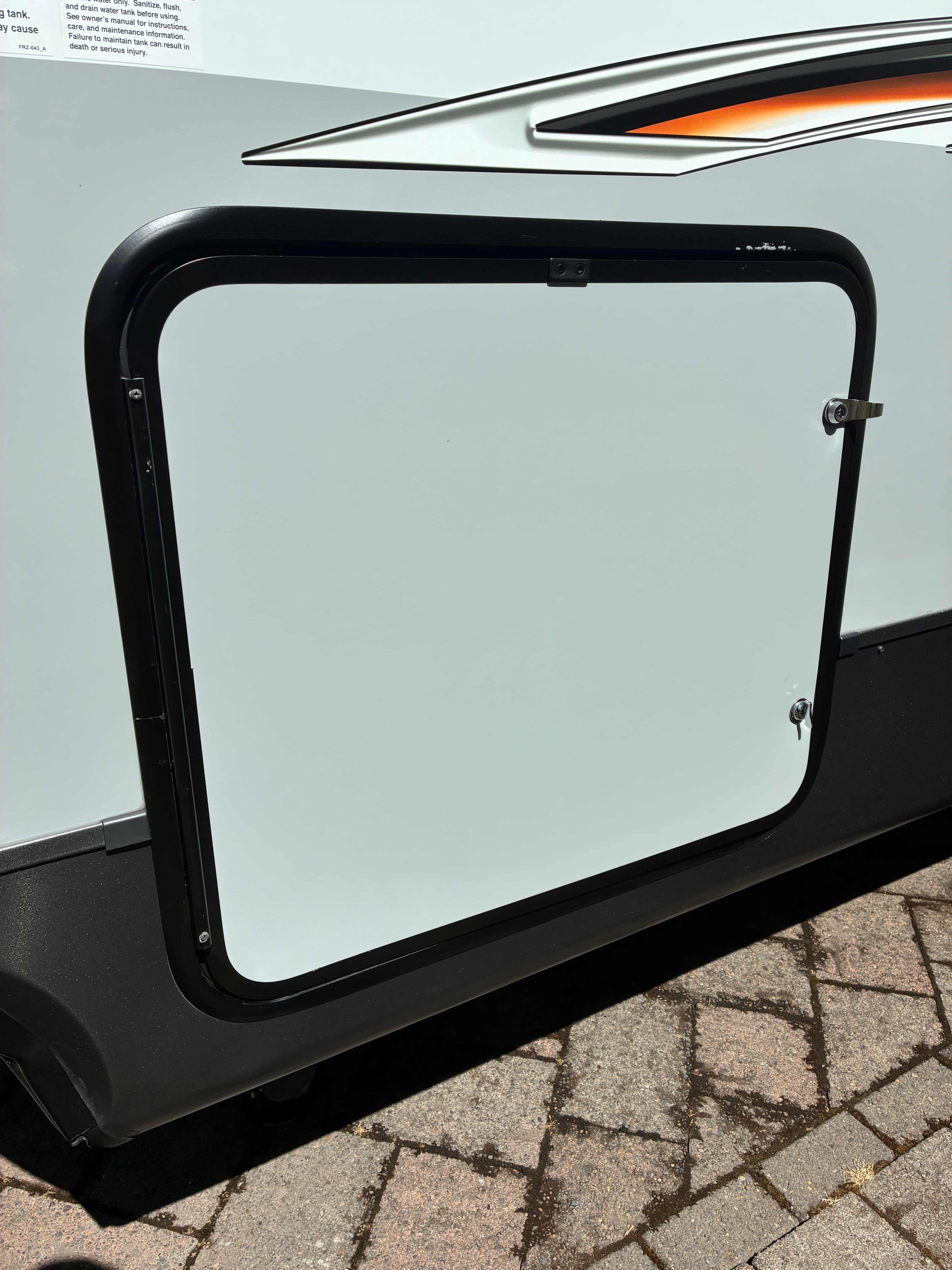 Travel trailer side panel after road grime cleanup and professional exterior wash and wax in Shoreline, WA