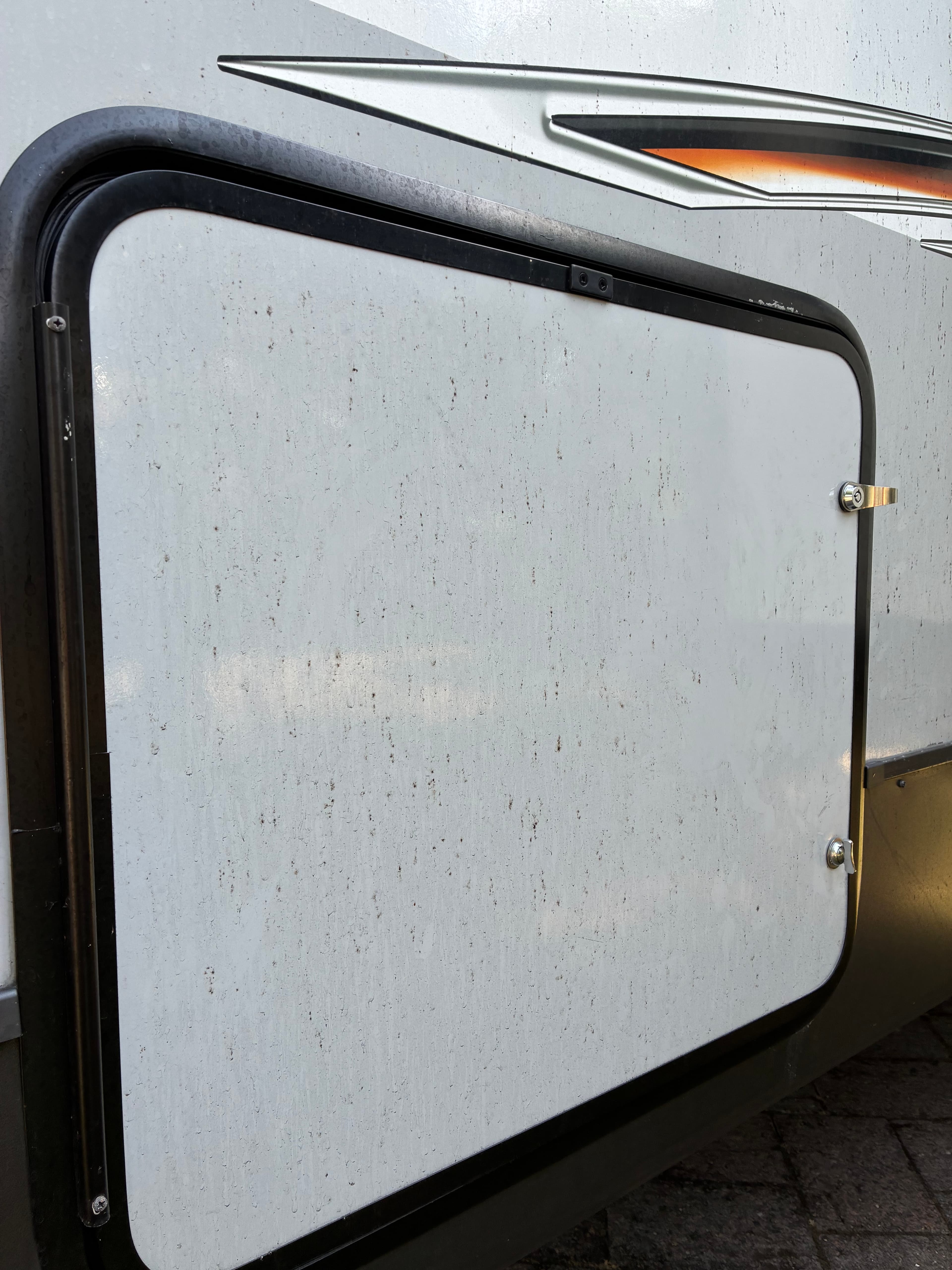 Travel trailer side panel with road grime before professional exterior wash and wax in Shoreline, WA